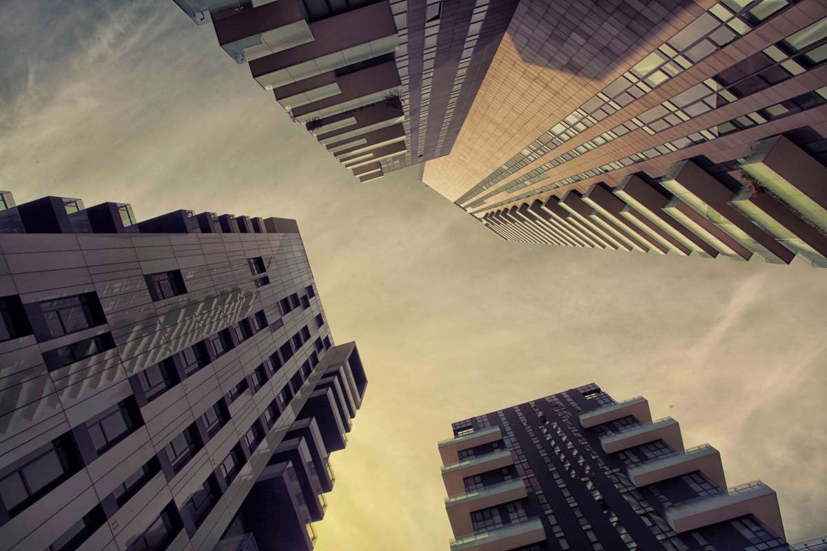 Three high-rise buildings shot from below with a "worm's eye view" perspective
