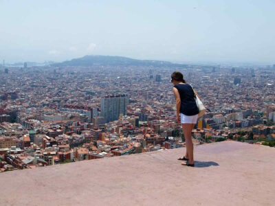 Person stood on a ledge looking over the city of Barcelona