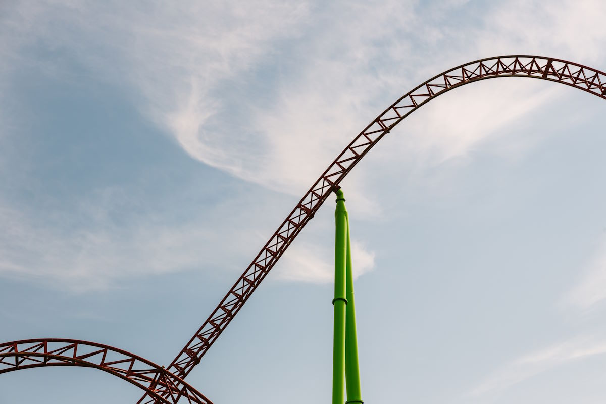 Hill of a roller coaster with green supports