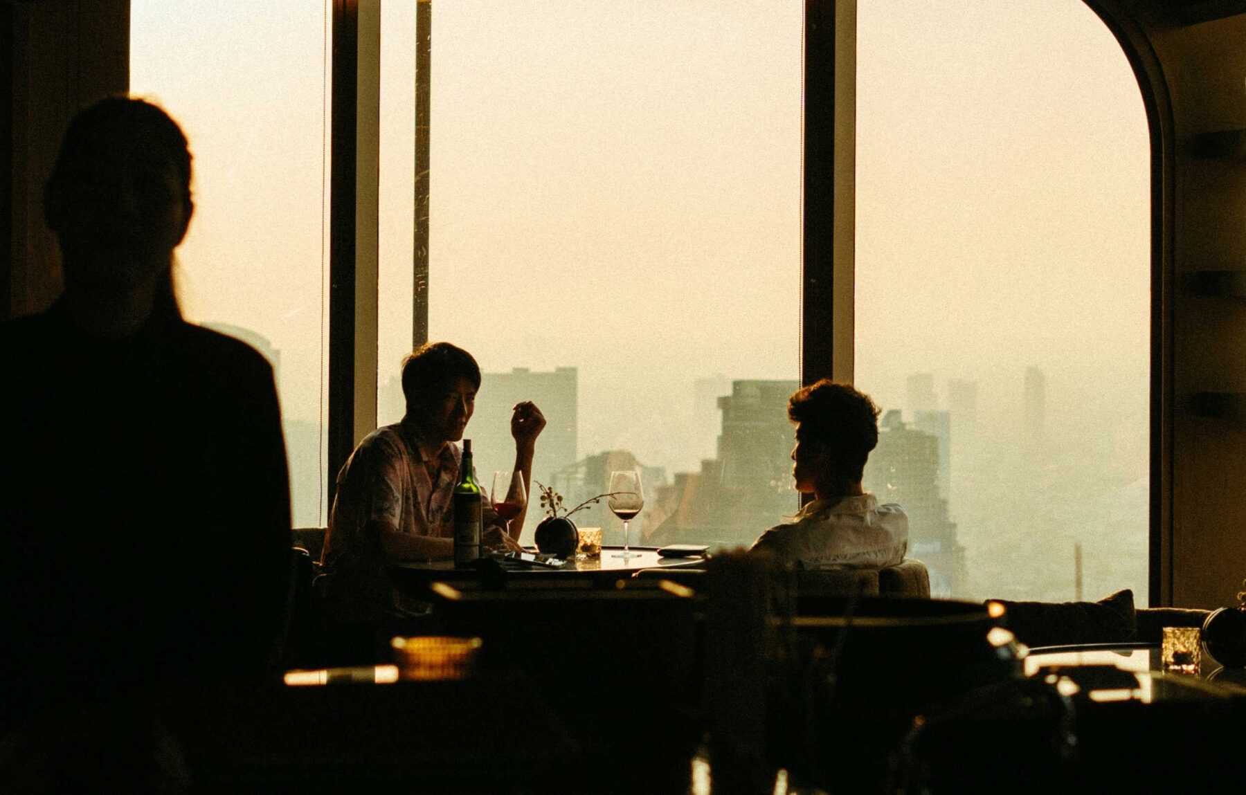 Photo of two people sitting in a restaurant of a high-rise building
