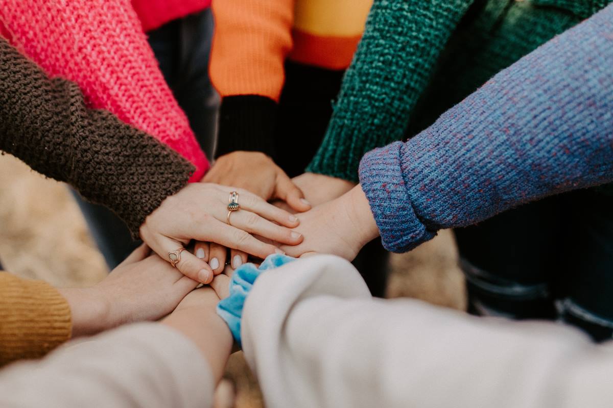 Two outstretched hands reach for each other