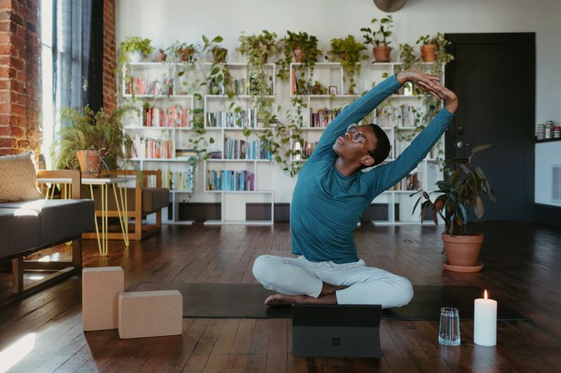 Man doing yoga in open living space