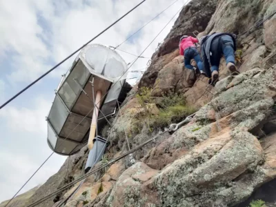 Two people climbing a via ferrata to reach a pod at Skylodge Adventure Suites